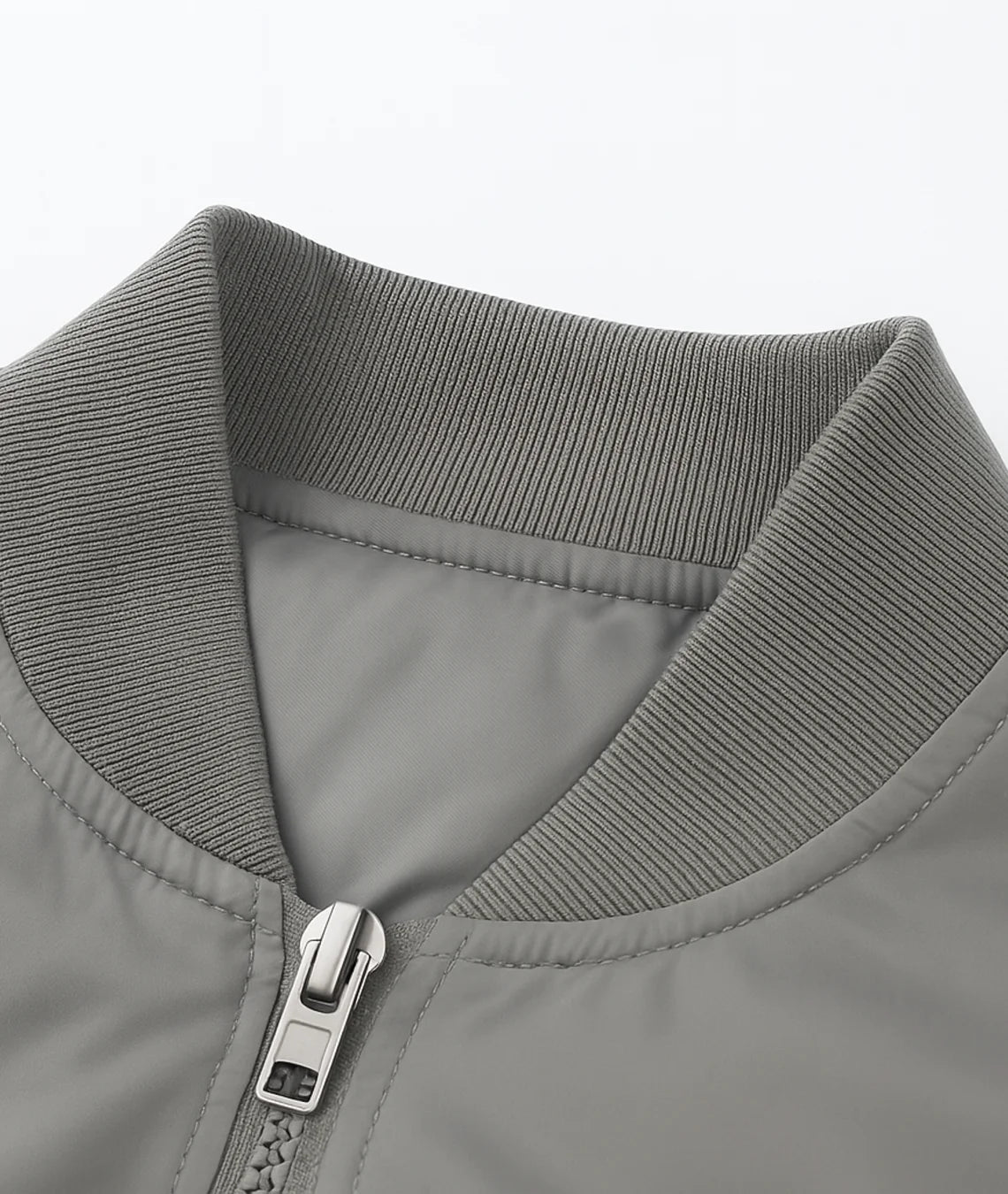 Close-up of a gray jacket collar with a zipper on a light gray background