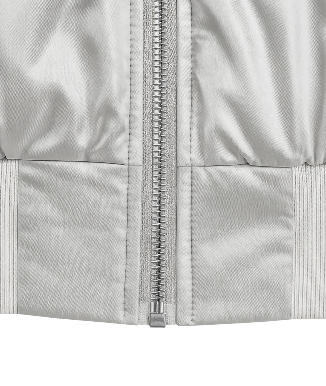 Close-up of a silver zipper on a light gray jacket
