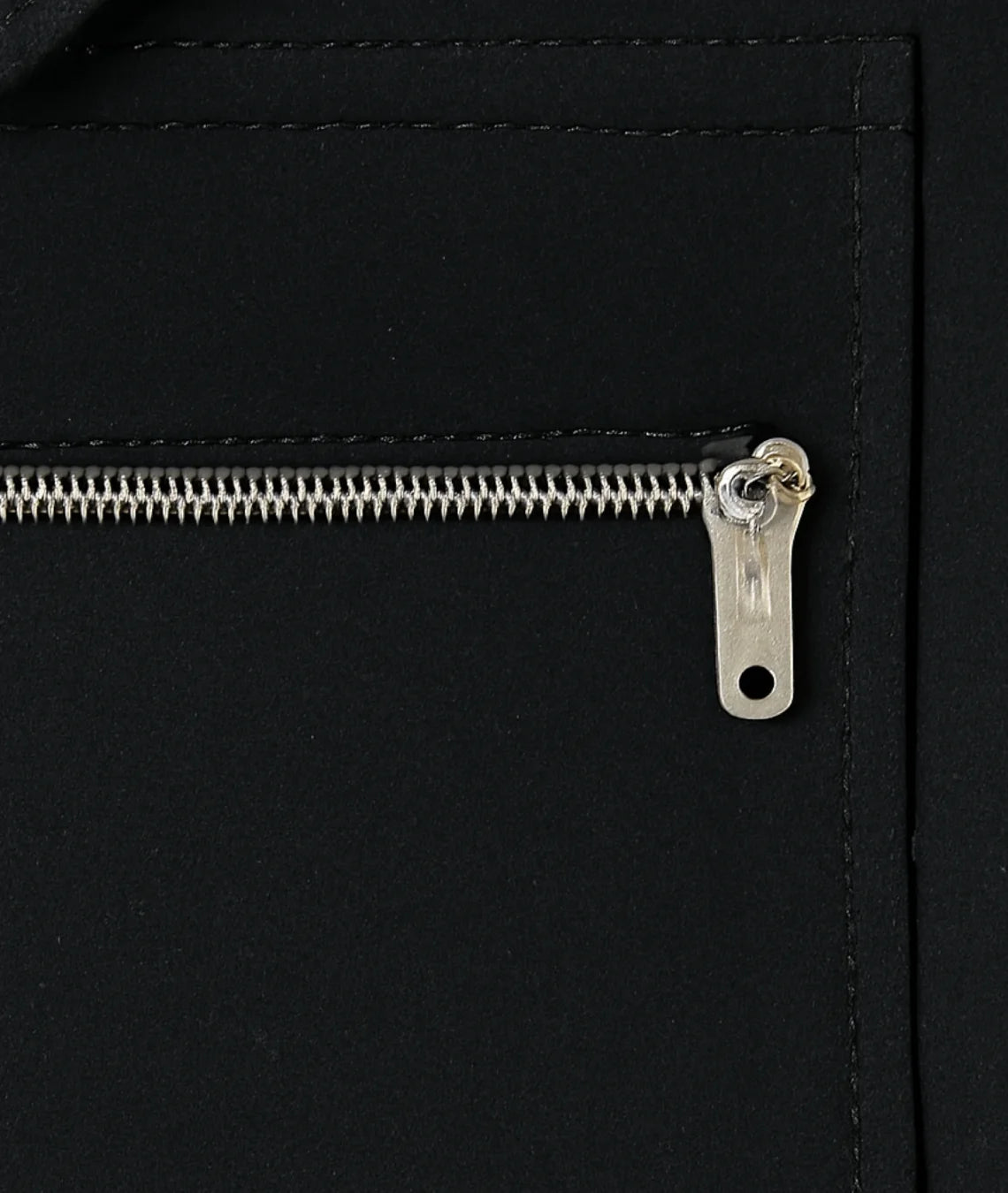 Close-up of a zipper on a black leather bag